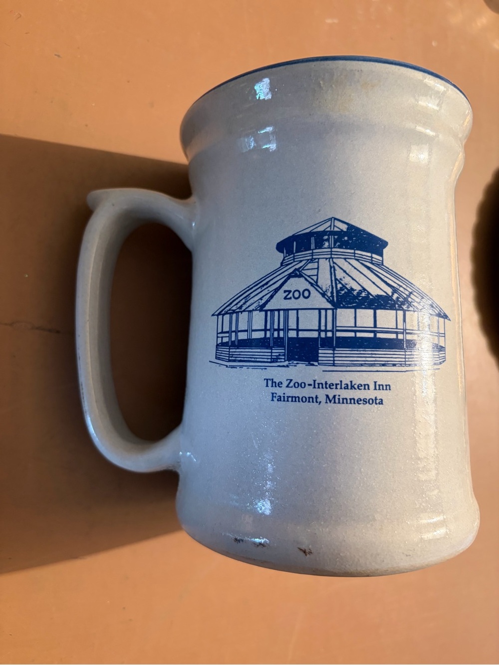White Ceramic Mug with Blue Zoo-Interlaken Inn Fairmont, Minnesota Logo